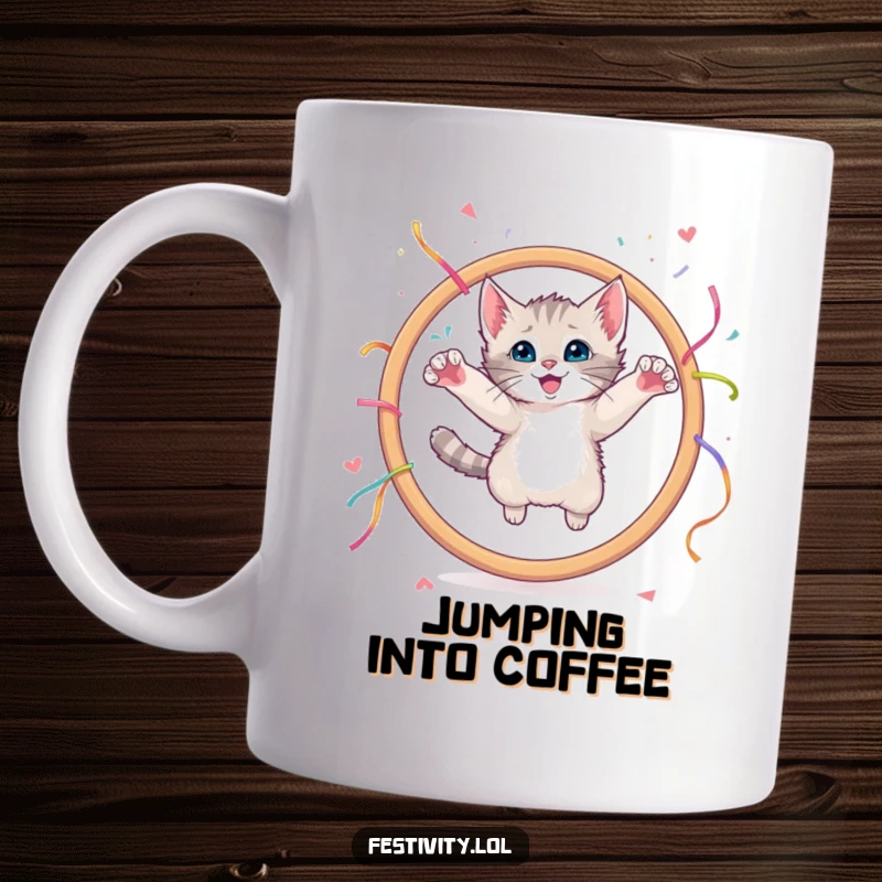 Funny mug showing a curious kitten leaping with excitement through a large hoop decorated with colorful streamers.