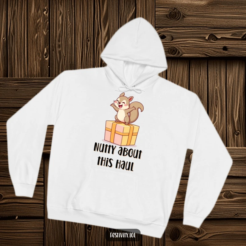 Funny hoodie featuring a gleeful squirrel energetically bouncing atop a comically large, festive present.